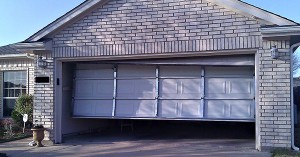 broken garage door that needs repair in Sachse, Texas